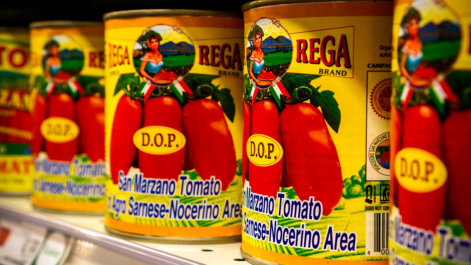 Cans of tomatoes on a shelf